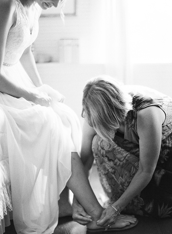 bride putting shoes on