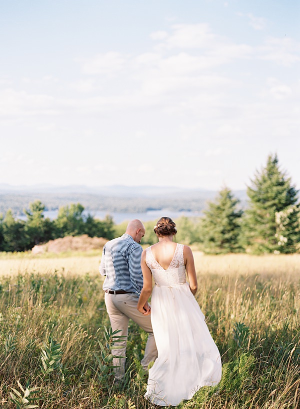 bride and groom in mountain field