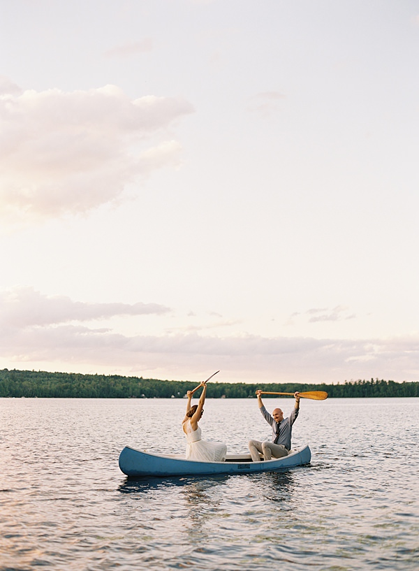 bride and groom in canoe at sunset